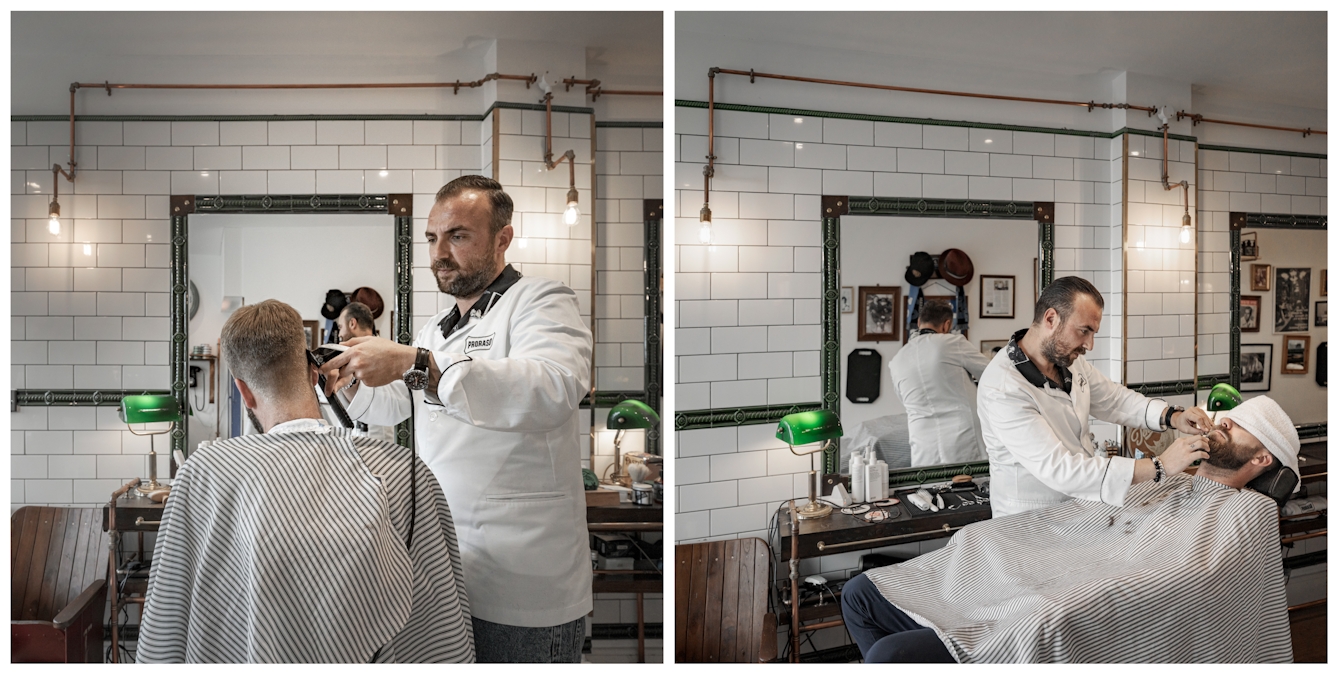 Photographic diptych. The photograph on the left shows a man from behind sitting in a barber's chair, draped in a white and grey striped hairdressing cape. To his right the barber is cutting his hair with clippers. The photograph on the right show the same man reclined in the chair, his eyes covered by a white towel. The barber stands next to him trimming his beard. 