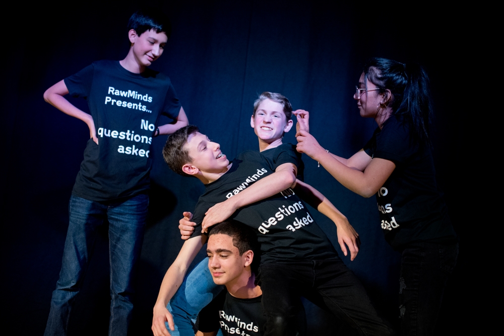 Photograph of a group of young people taking part in an improv comedy performance as part of the Wellcome Collection Raw Minds programme.