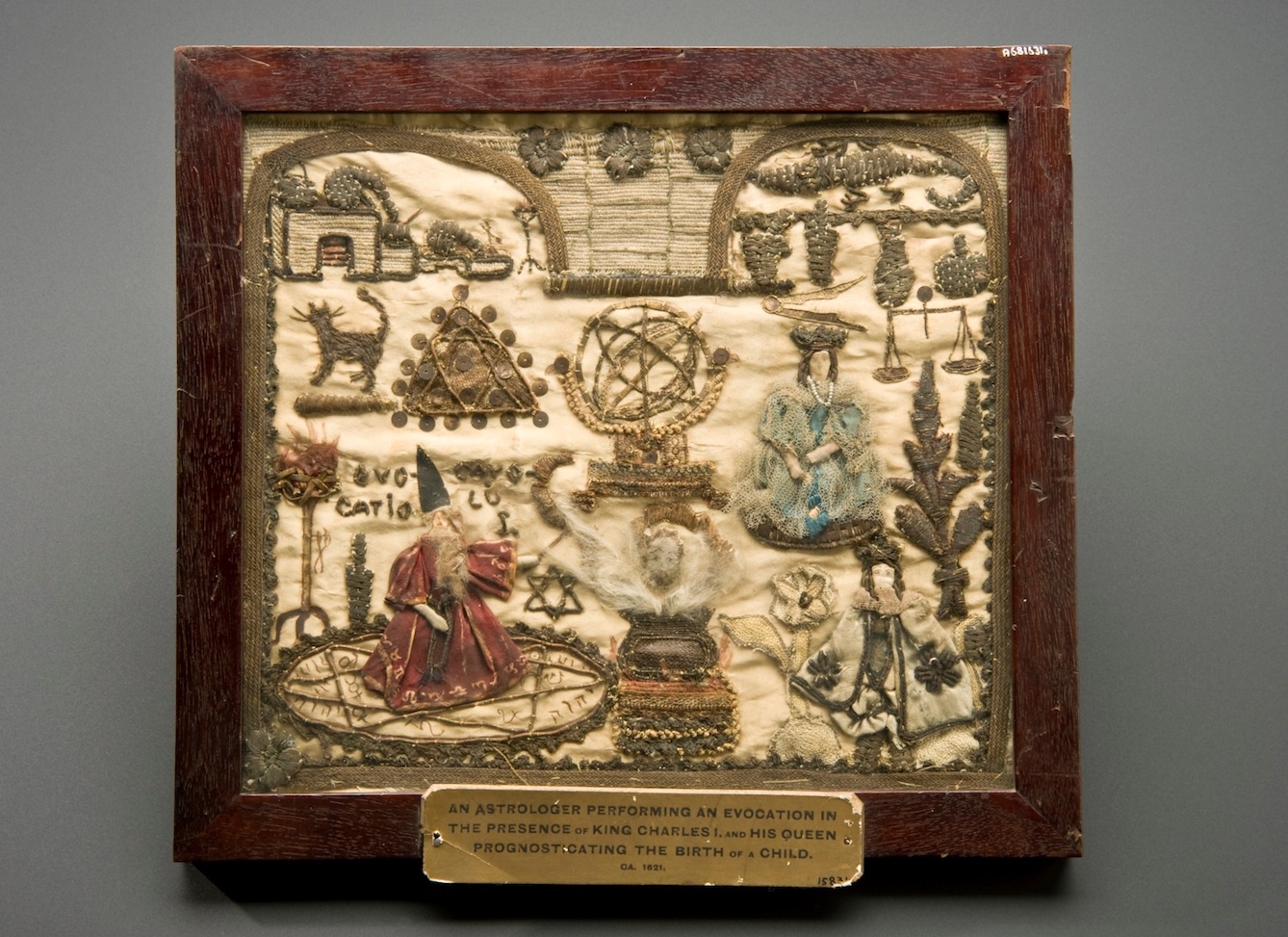 Image of embroidered square with wooden frame.