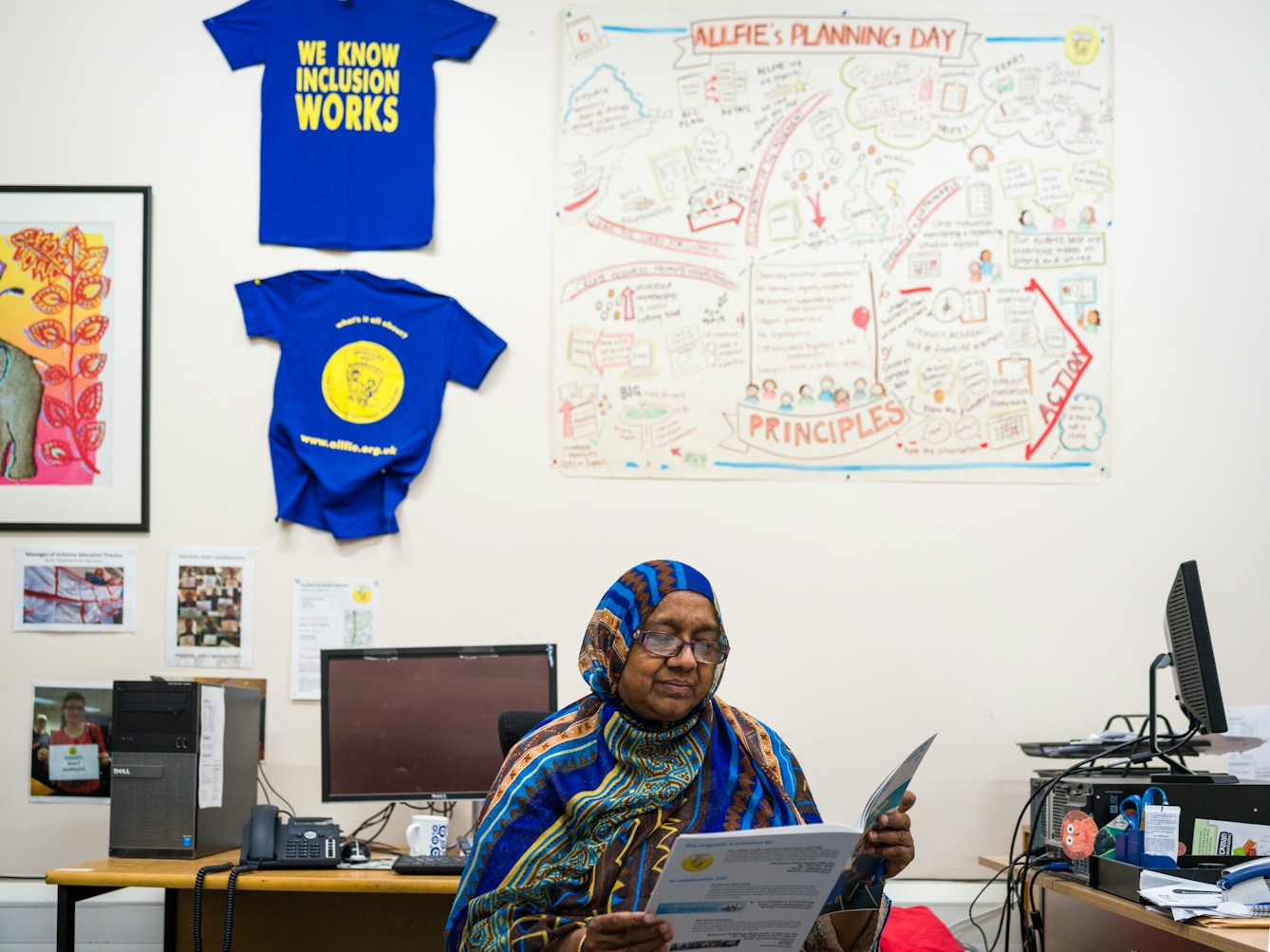 Photograph of Sarifa Patel reading before a meeting of the Trustees of the charity, ALLFIE.