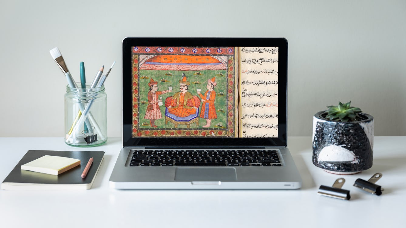 A laptop sitting open on a desk showing a close up of a decorative illustration and text from an Arabic manuscript on the screen.