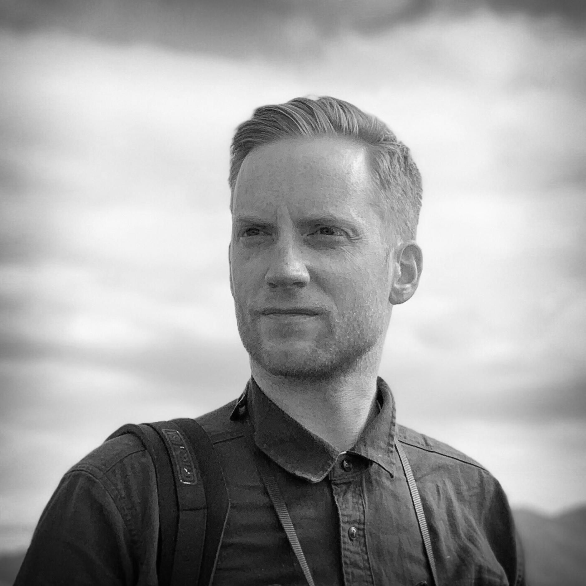 Black and white, head and shoulders portrait of Kieran Dodds.