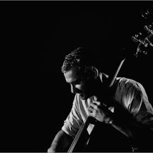 Black and white photograph of Liran Donin playing the double bass.