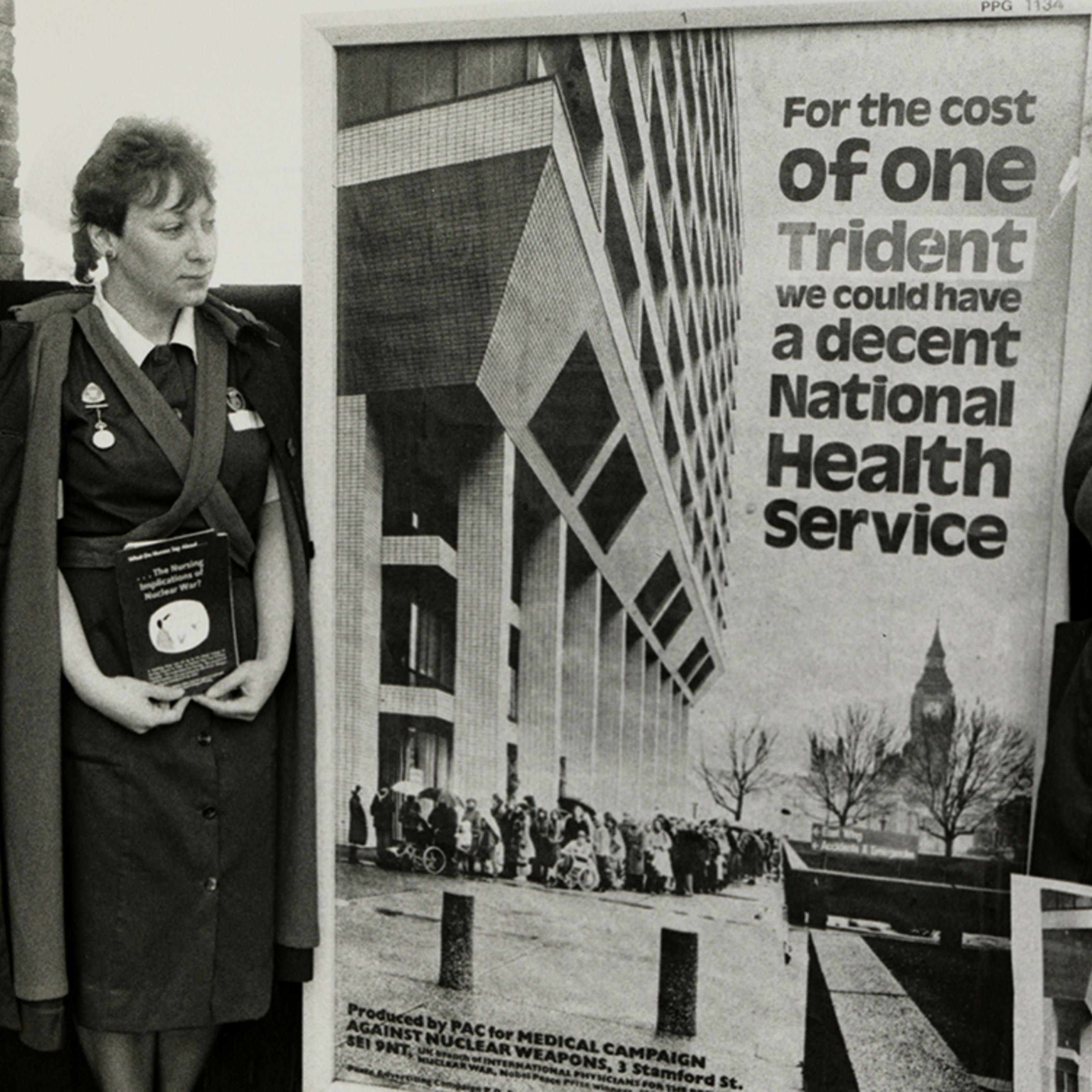 A protest by nurses holding a banner advocating health spending over military spending