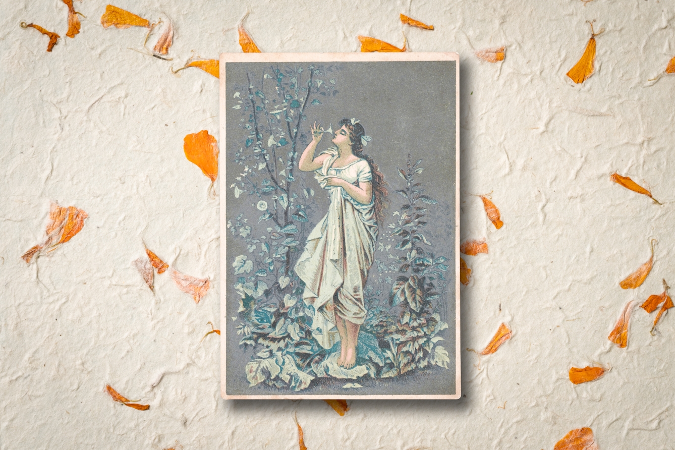 An image of a 19th-century medicinal advertising card. The card shows a woman with long brown hair wearing a white dress. The woman is barefoot and smelling the flowers of the plants surrounding her. Behind the card is a background of orange petals.