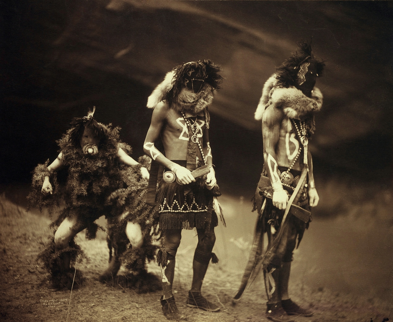 A 'Yebichai Sweat' Navajo medicine ceremony: three Navajos in ceremonial dress with faces masked