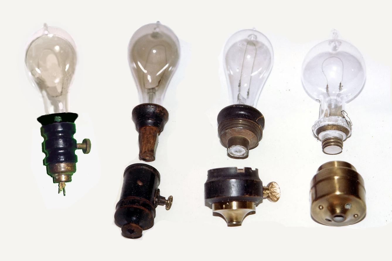Colour photograph of four light bulbs with single curved wire filaments