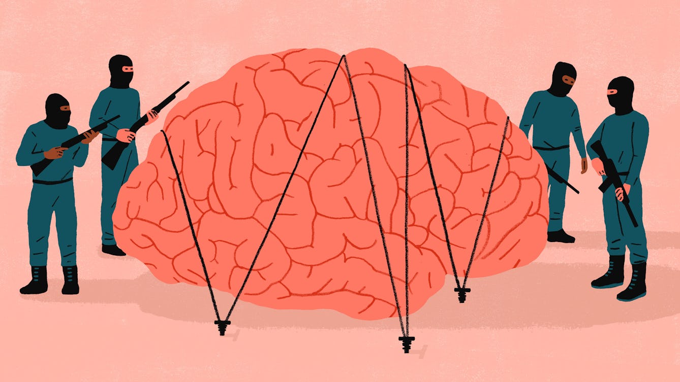 Four armed guerrillas guard a giant brain held in place with bungees.