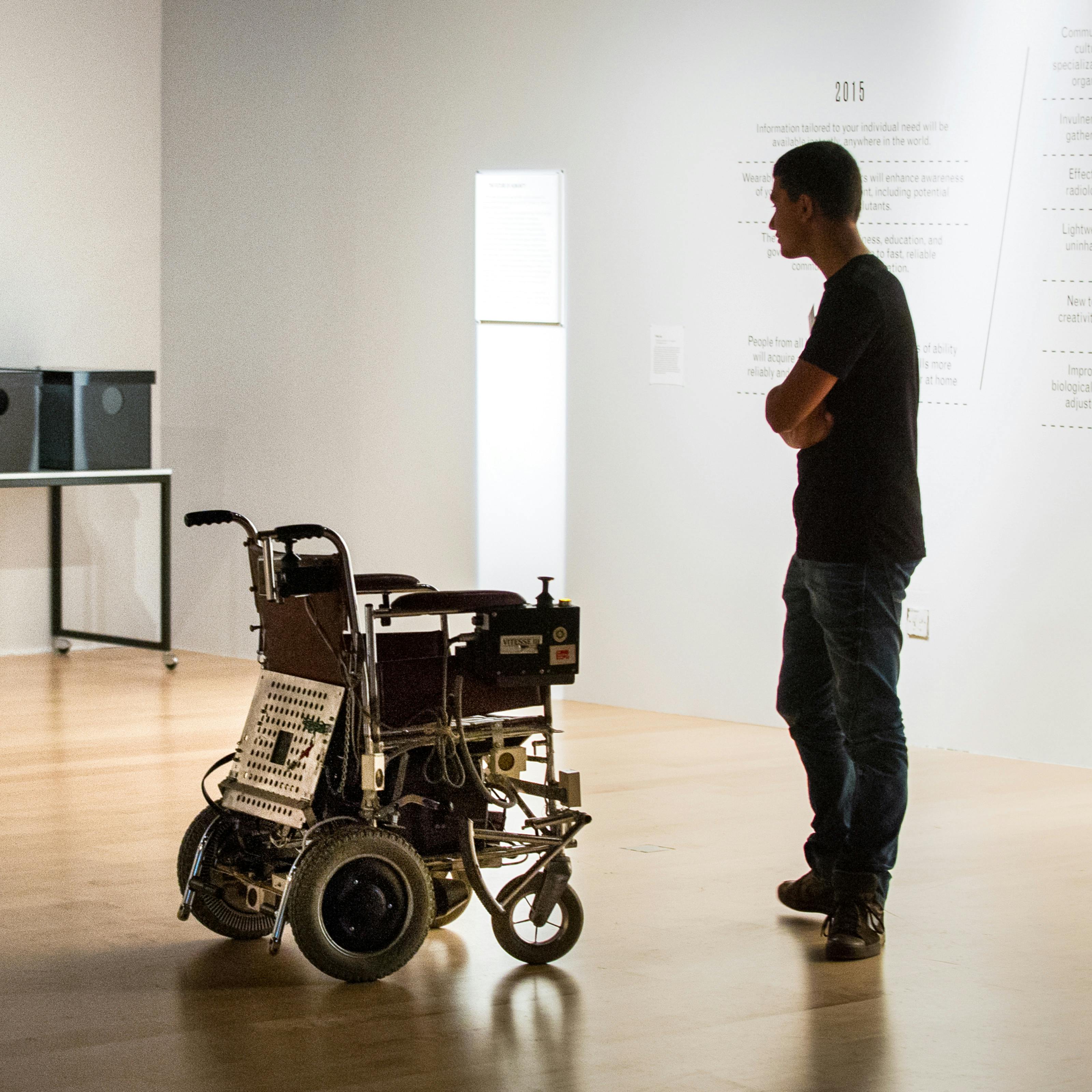 Photograph of a young man exploring the exhibition, Superhuman at Wellcome Collection.