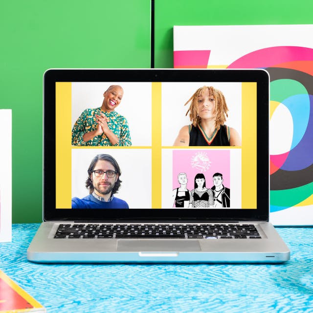 Photograph of a laptop on a desk with a blue patterned surface.  On the laptop screen is a portrait of Gaylene Goud, Rene Matić, Ben Walters and Queer House Party. Next to the laptop are headphones and a pink card. In the background is a LP vinyl record leaning against a bright green cabinet. 