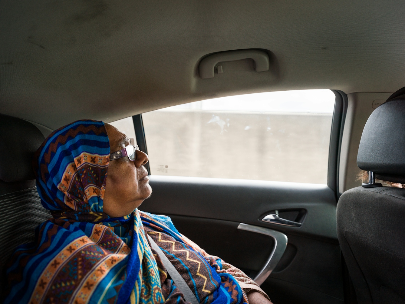 Photograph of Sarifa Patel relaxing in the back of a taxi.