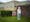 Photographic full length portrait of Joyce Thompson, retired nurse, outside the Royal Blackburn Hospital.
