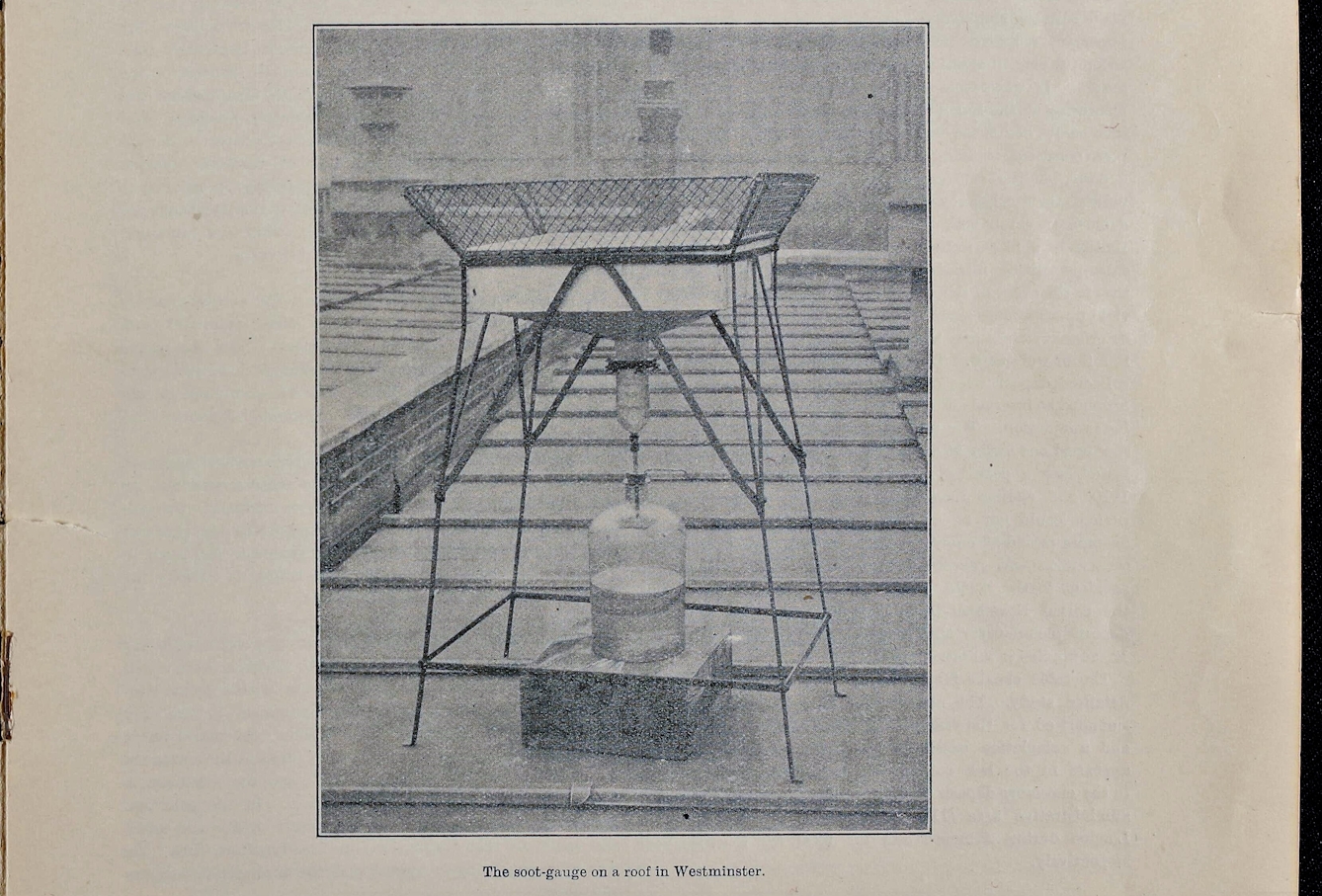 Picture of a black and white image printed in a book captioned "The soot-gauge on a roof in Westminster." The device is a square metal stand with a funnel-like component filtering into a glass-looking tube, which then connects to a narrow metallic tube that passes through a cork into a large jug bottle below. 