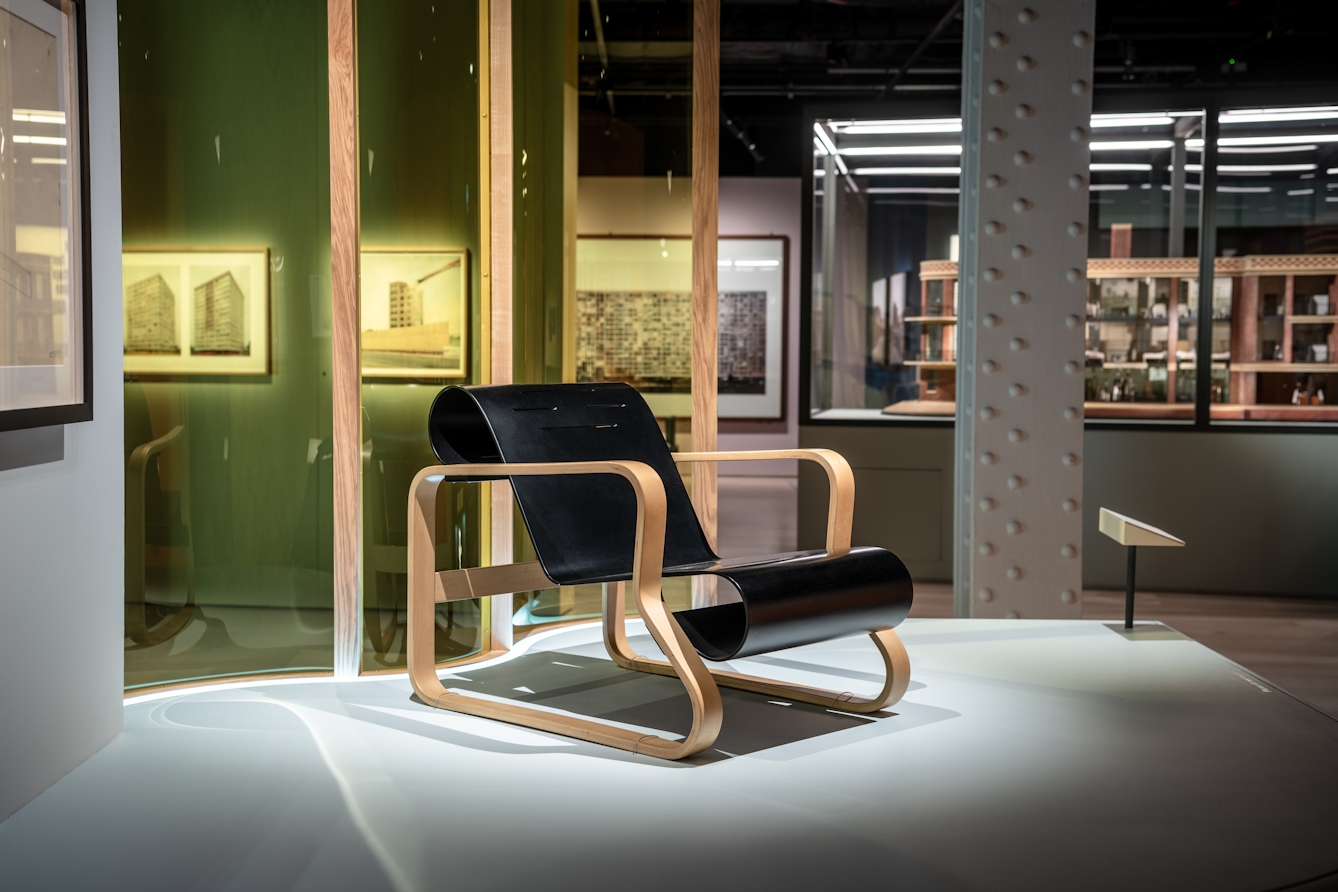 Photograph of a wooden chair from the Paimio Sanatorium, exhibited as part of the exhibition, Living with Buildings at Wellcome Collection.