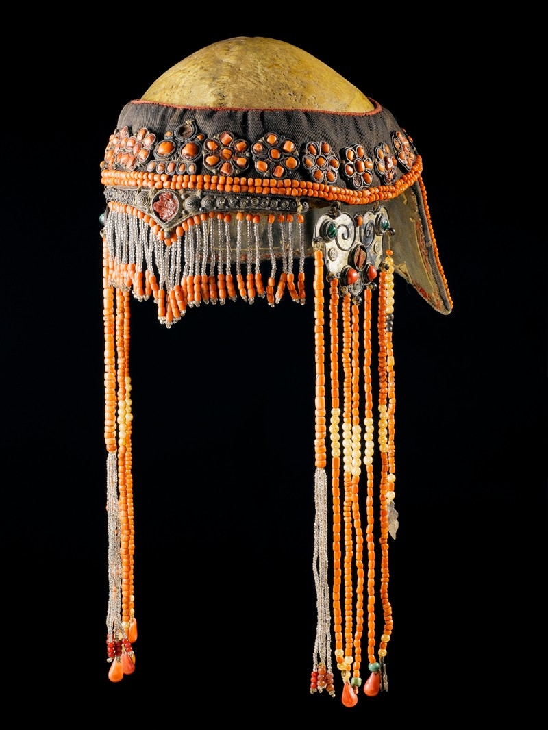 Image of beaded ceremonial headdress overlaying a human skull