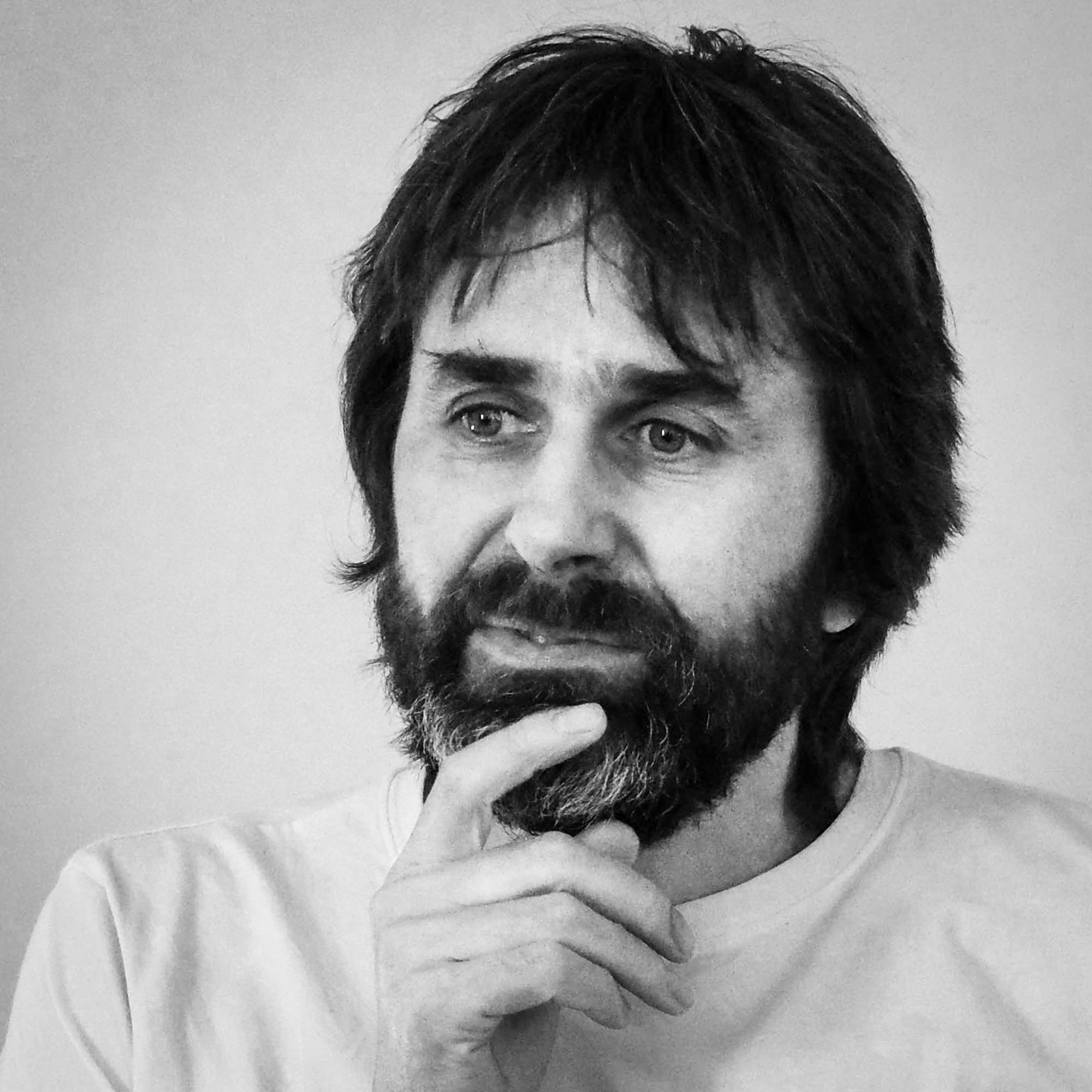 Black and white head and shoulders photographic portrait of Julian Germain.