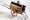 Photo of a wooden box on wheels with protruding rods for pulling along.
