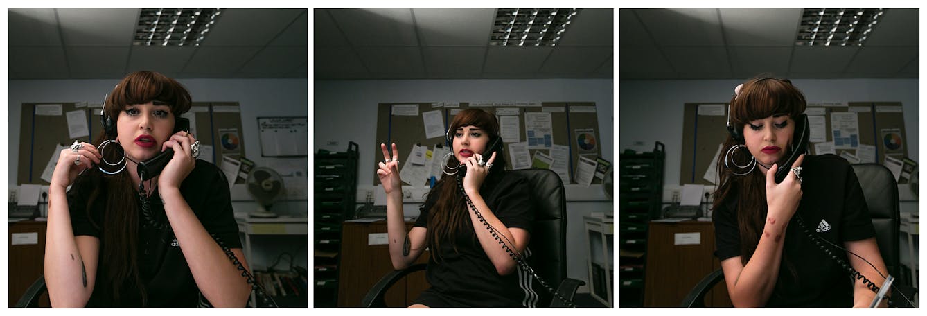 Photographic triptych showing the same woman in each image, sat in an office environment. In the left hand image the woman holds a landline telephone receiver to her left ear, her right hand is raised holding her large hoop earrings. She is looking straight into camera. In the middle image she holds the receiver to her left ear and she is looking away to camera left, mid sentence. Her right hand is raised.In the right hand image she holds the receiver to her left ear with her right hand and she is looking down to the desk.