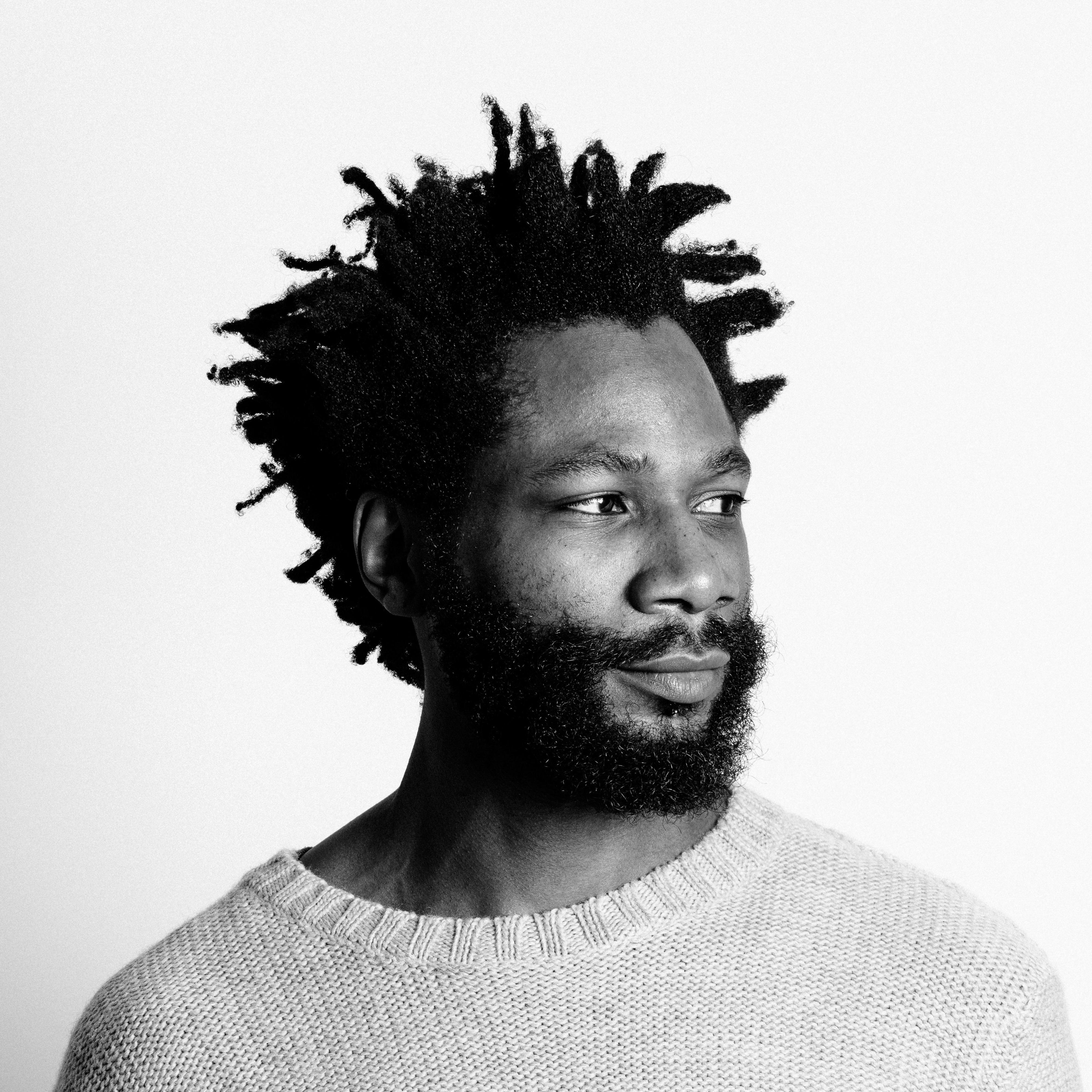 Head and shoulders, black and white photographic portrait of Michael Salu.