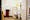 Photograph though the doorway of an accessible toilet showing part of the door and doorframe, along with the contents of the room, toilet, basin and sanitary bins. The room looks run down and dirty.