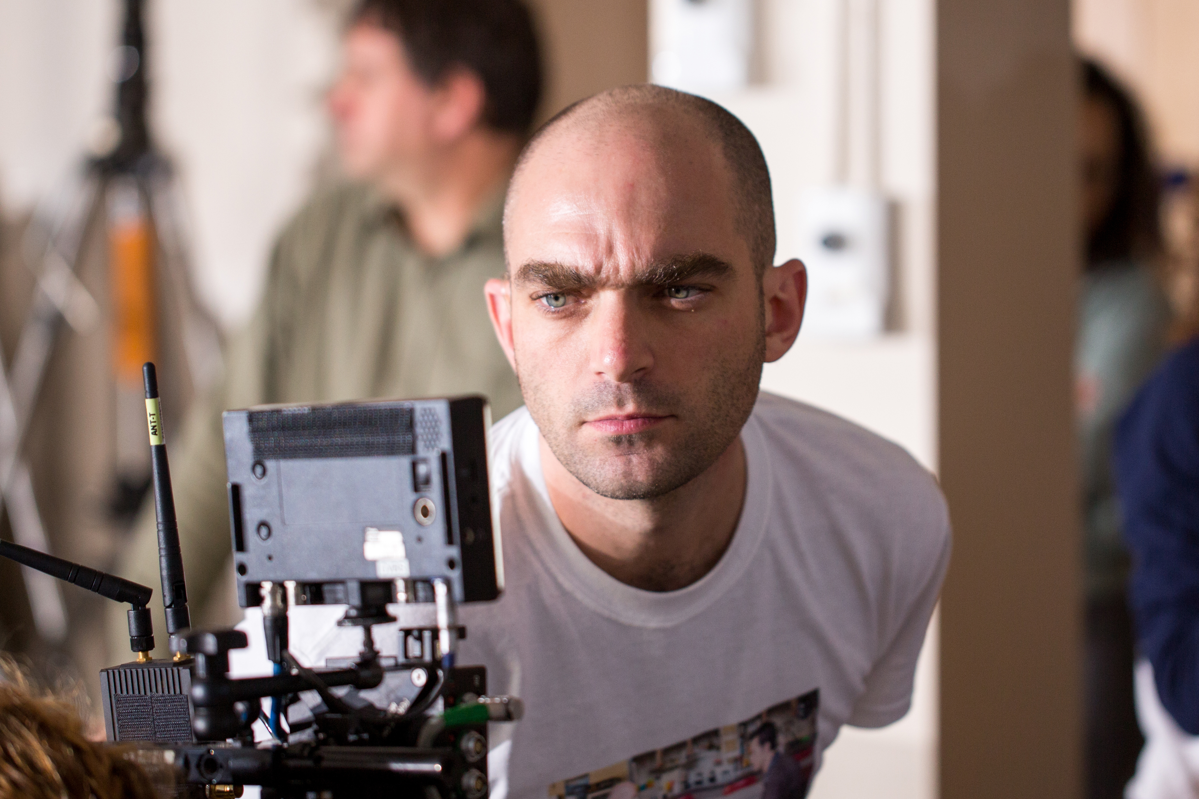 Photo of a man looking into a video monitor