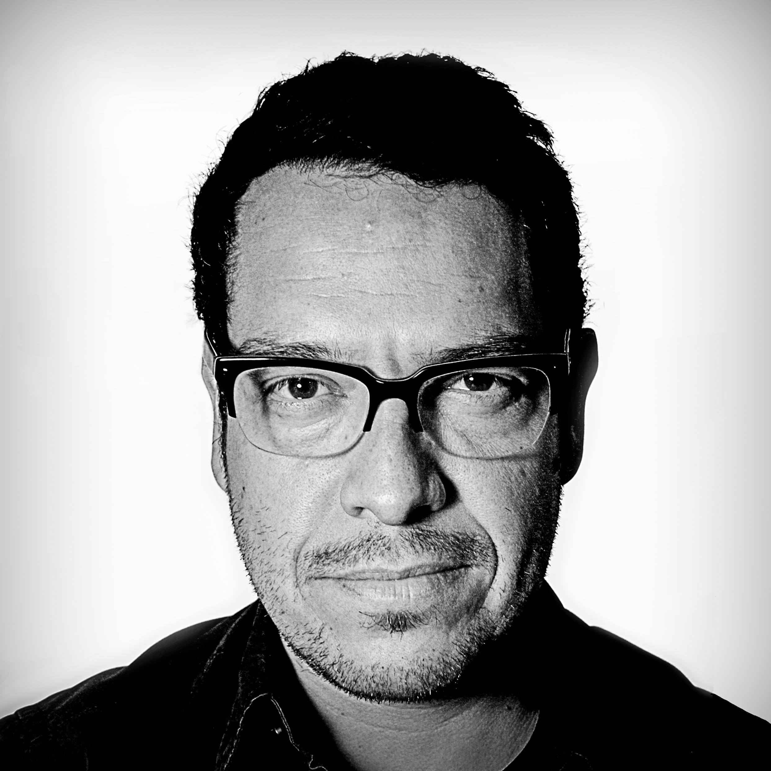Photographic, black and white, head and shoulders portrait of Eduardo Rubio.