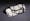 Colour photograph of a black and white ceramic pillow in the shape of a woman reclining.