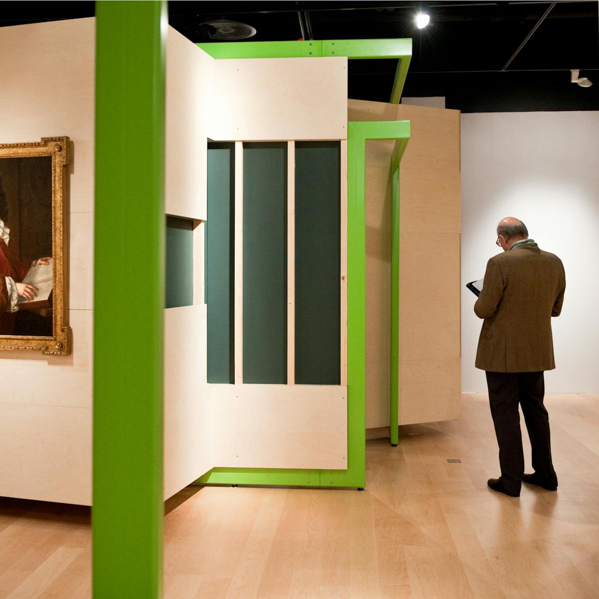 Photograph of a visitor exploring the Identity exhibition at Wellcome Collection.