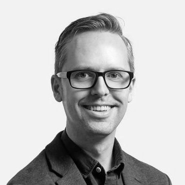 Black and white photograph of Adrian Plau, head and shoulders portrait.