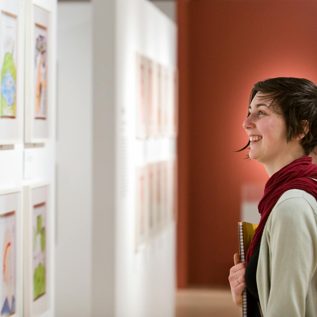 Photograph of visitors exploring the Bobby Baker’s Diary Drawings exhibition at Wellcome Collection.