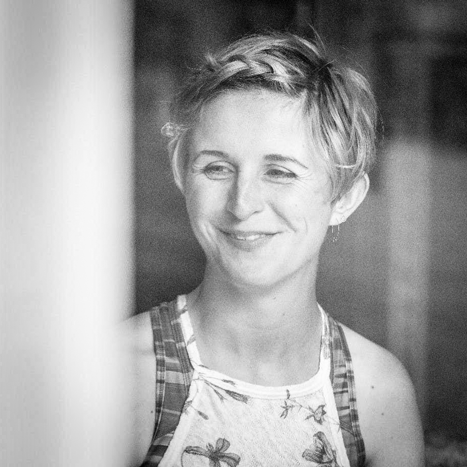 Black and white, head and shoulders portrait of Hannah Dines.