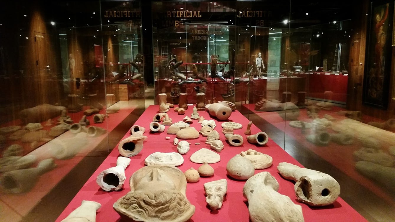 A glass case of sculpture fragments in ‘Medicine Man’ at Wellcome Collection