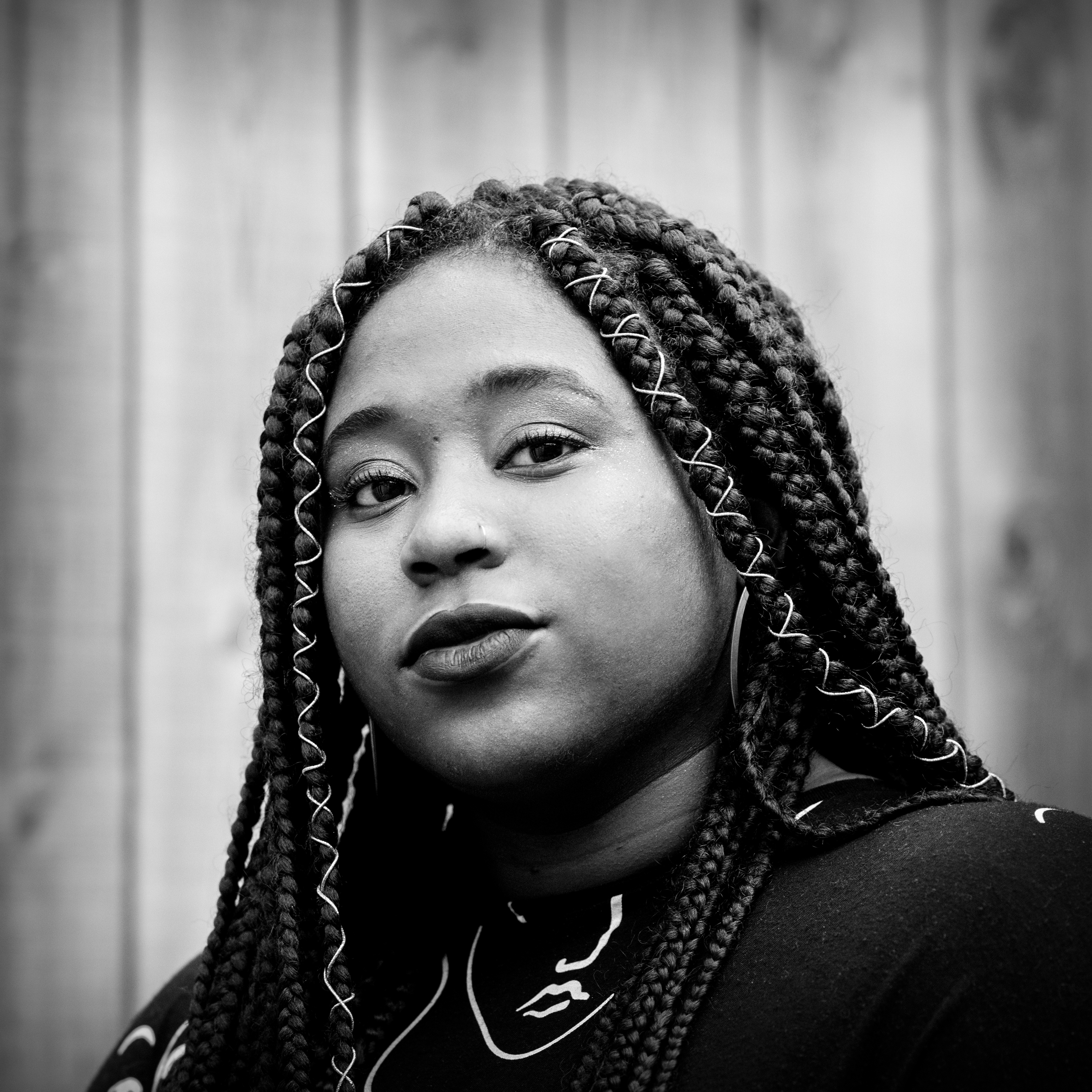 Photographic, black and white, head and shoulders portrait of Rianna Walcott.