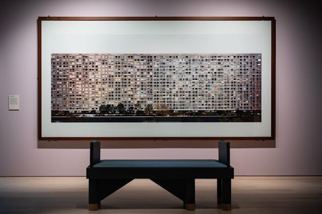 Photograph of framed works on hanging on the wall of the exhibition, Living with Buildings at Wellcome Collection.