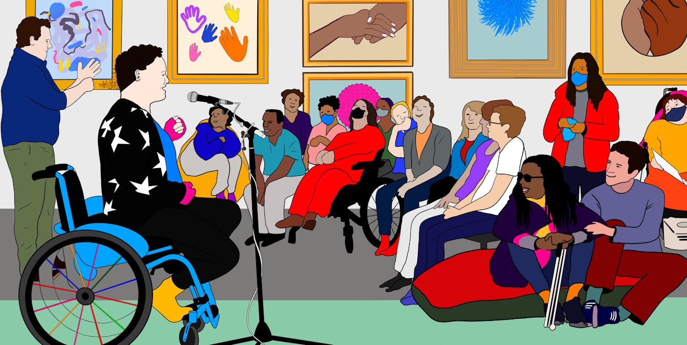 A colourful digital drawing of Jess Thom, a white woman with short curly hair in her blue wheelchair wearing pink fingerless gloves and a black jumper with stars on. She is speaking into a standing microphone to an audience in Wellcome Collection’s Reading Room. Next to her is a BSL interpreter who is communicating in sign language to the audience. People in the audience are smiling and listening to the talk, some are wearing masks. Some people are standing, others are seated on chairs and large cushions. Behind them on the gallery wall are colourful framed illustrations of colourful waving hands, and a pink spherical object.
