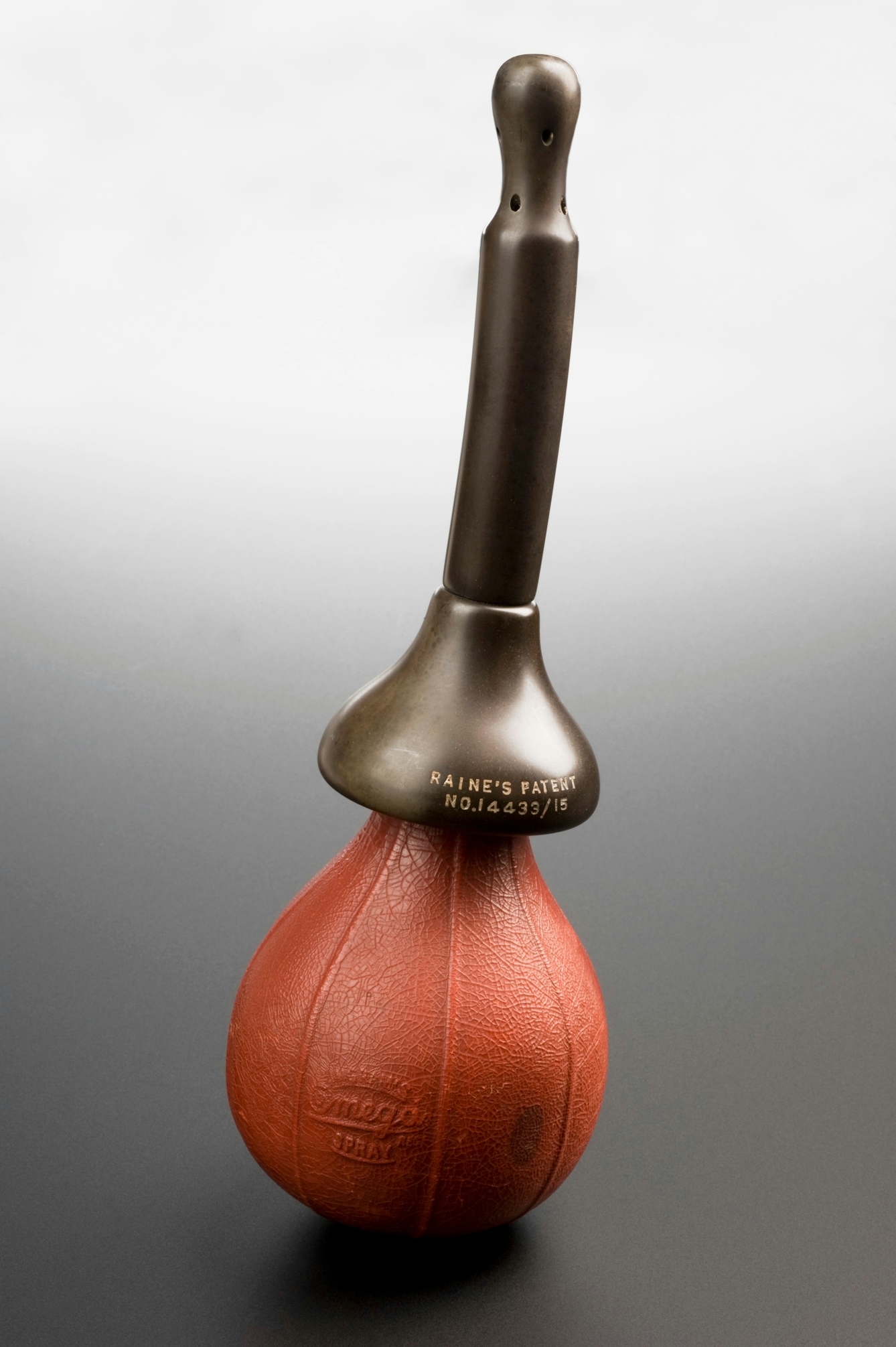 Photograph of a vaginal douche made out of rubber and vulcanite, the 'Omega Spray', made by Ingram in England and patented by Raine, 1900-1940.
