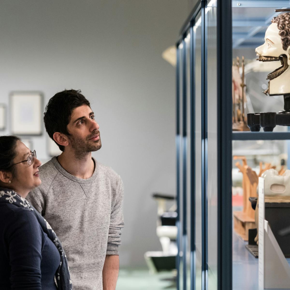 Photograph of a man and a woman looking at an exhibit in the Teeth exhibition at Wellcome Collection.