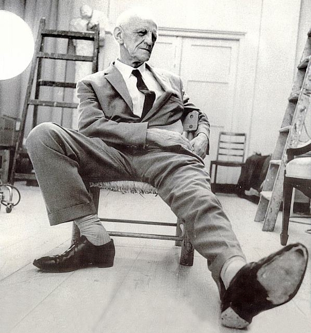Portrait photograph of Donald Winnicott, his left foot outstretched towards the camera.
