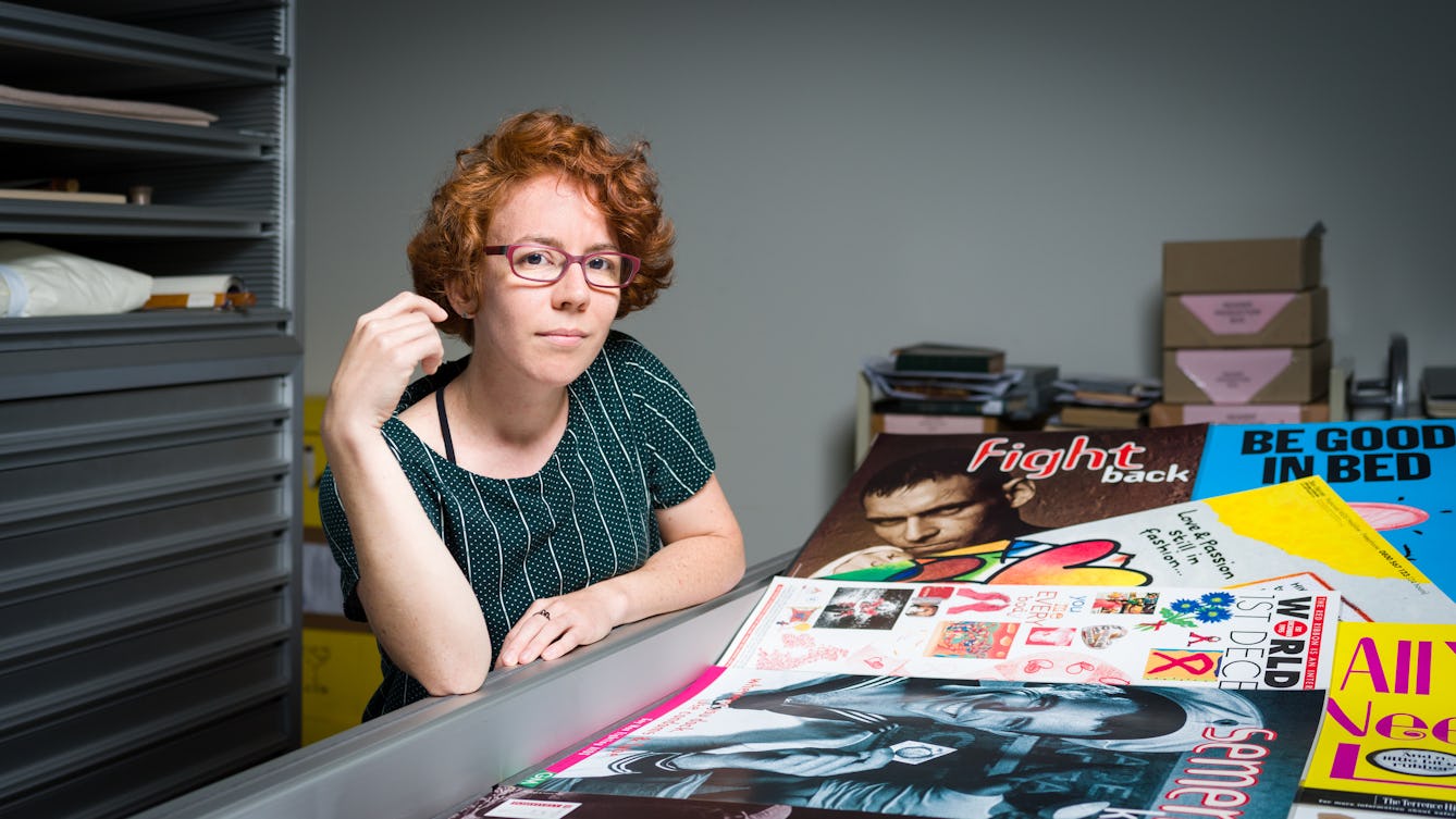 Photographic Portrait of Dr Hannah J Elizabeth looking at AIDS related material in the Wellcome Collection library stores.