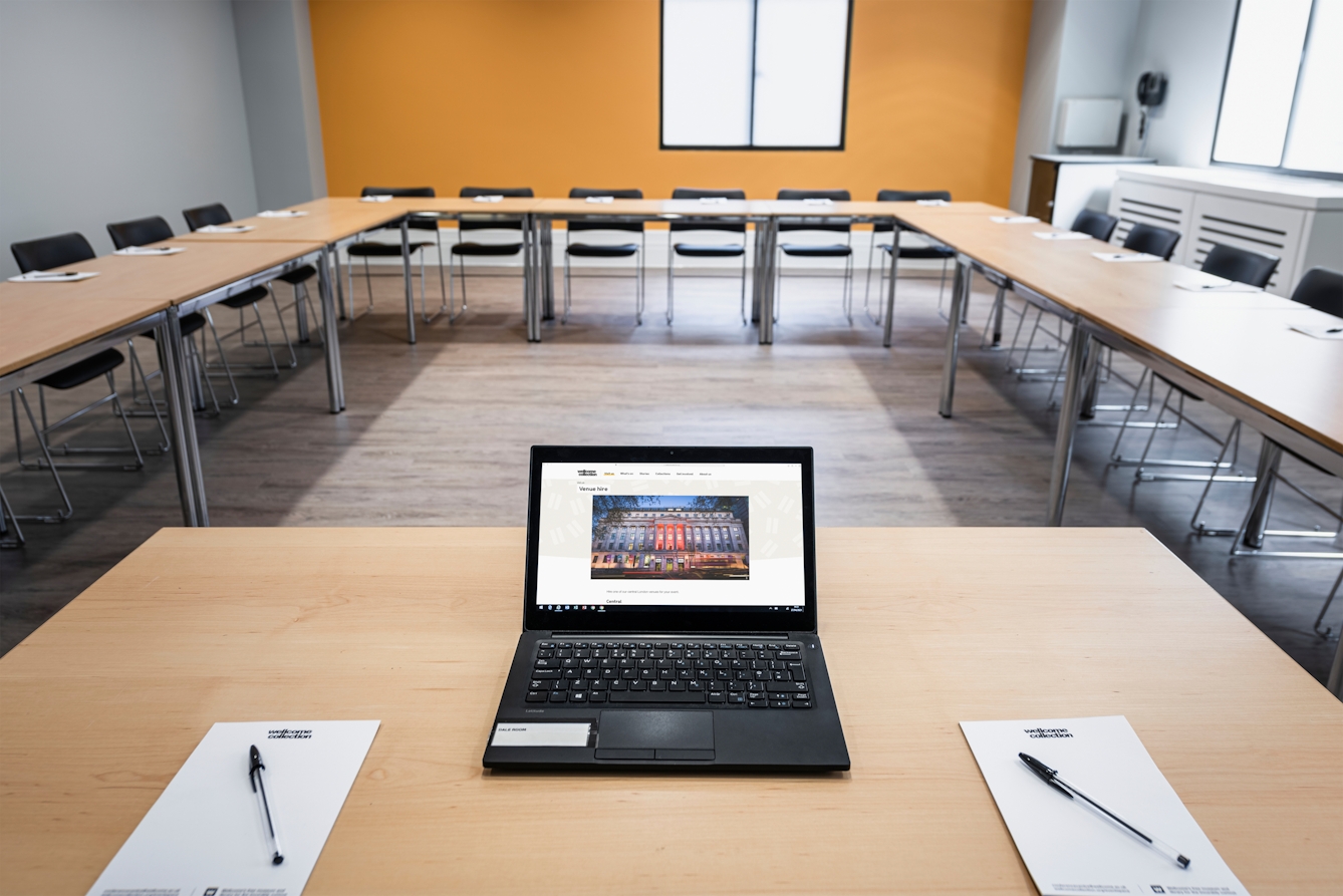 Photograph of the Dale room at the Wellcome Collection. 

Photograph shows a boardroom set-up and an open laptop on a desk. 