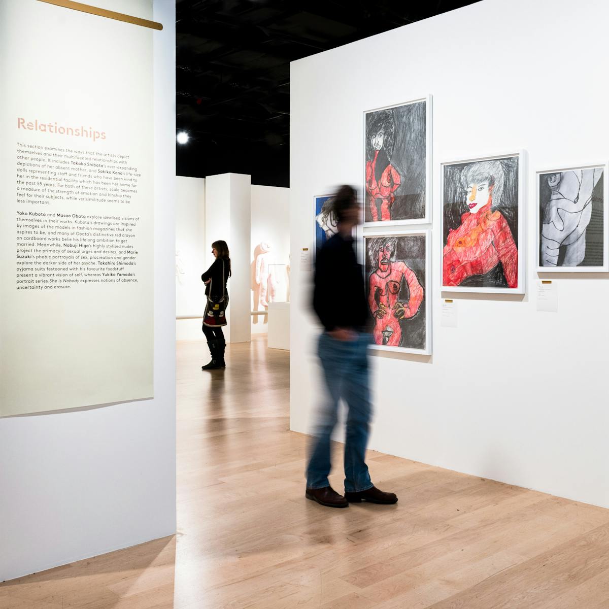 Photograph of visitors exploring the exhibition, Souzou: Outsider Art from Japan, at Wellcome Collection.