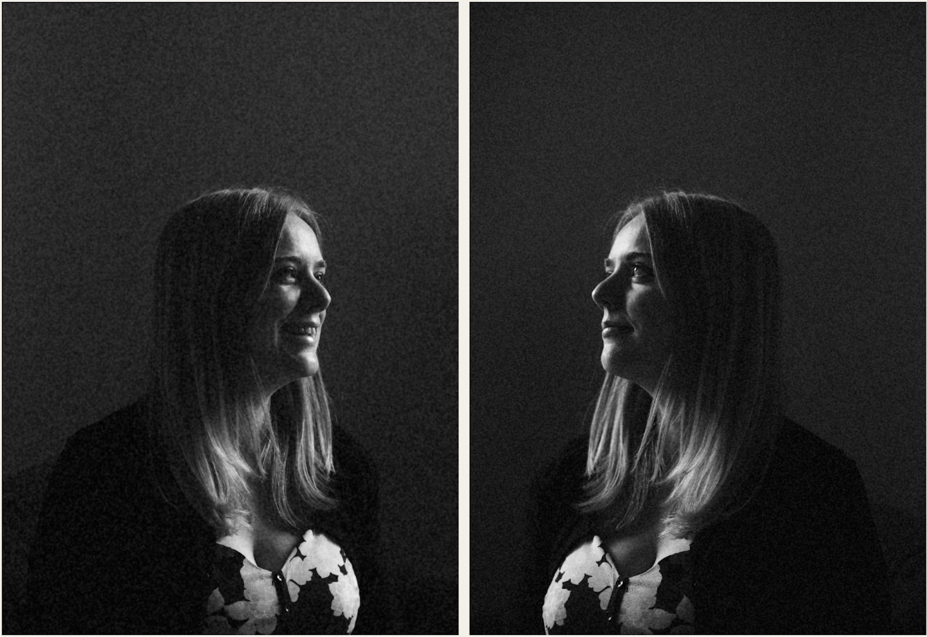 Photographic black and white diptych. The images both show the same young woman with blond hair, wearing a floral dress. In each image she is pictured in profile, looking towards herself in the other image, as if in a mirror. The image is very dark in tone, with just her profile picked out in the light. In the image on the left the woman is smiling. In the image on the right she has a more neutral expression.