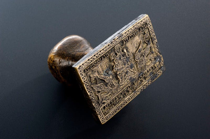 Image of small wooden stamp with medieval image.