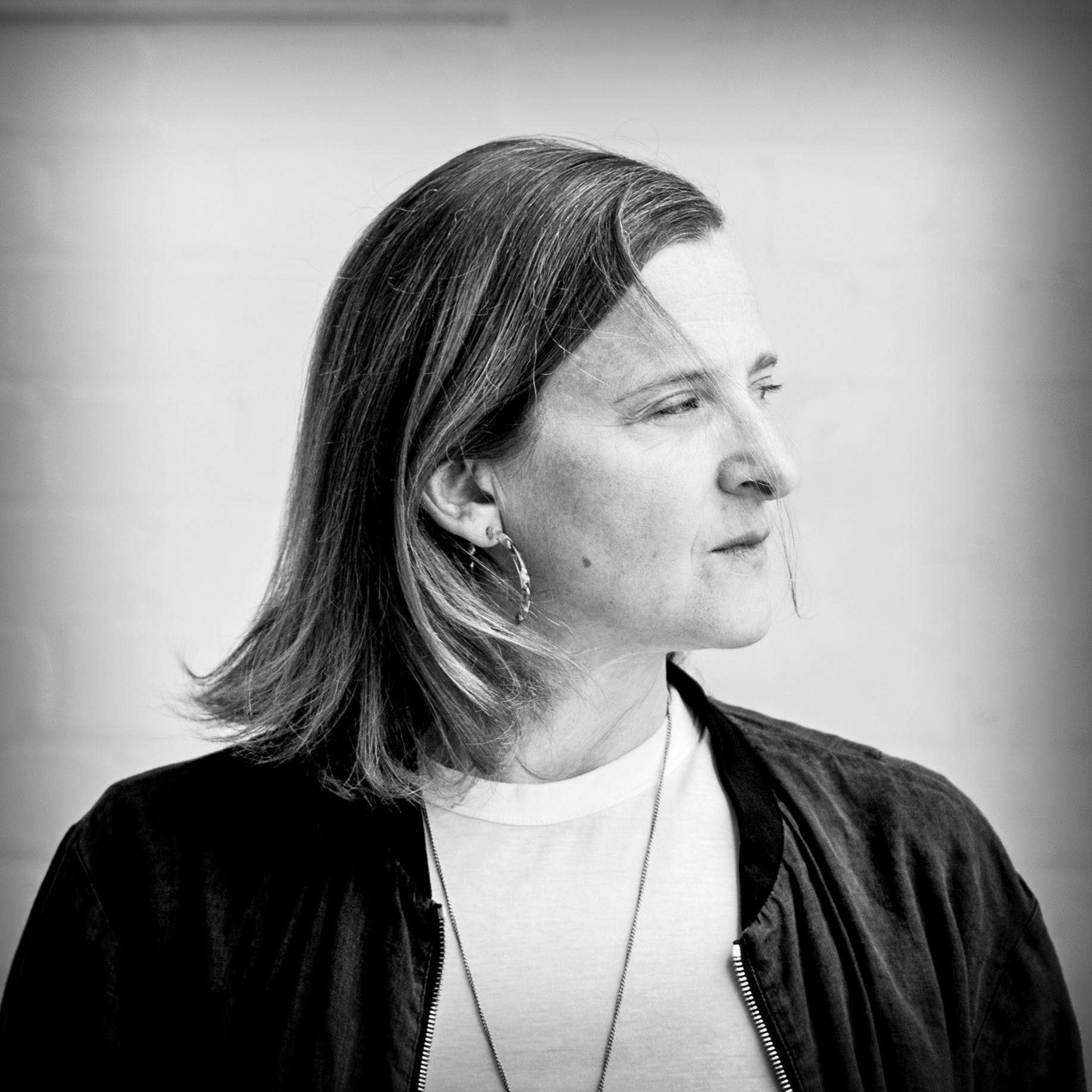 Black and white, head and shoulders portrait of Emma Warren.