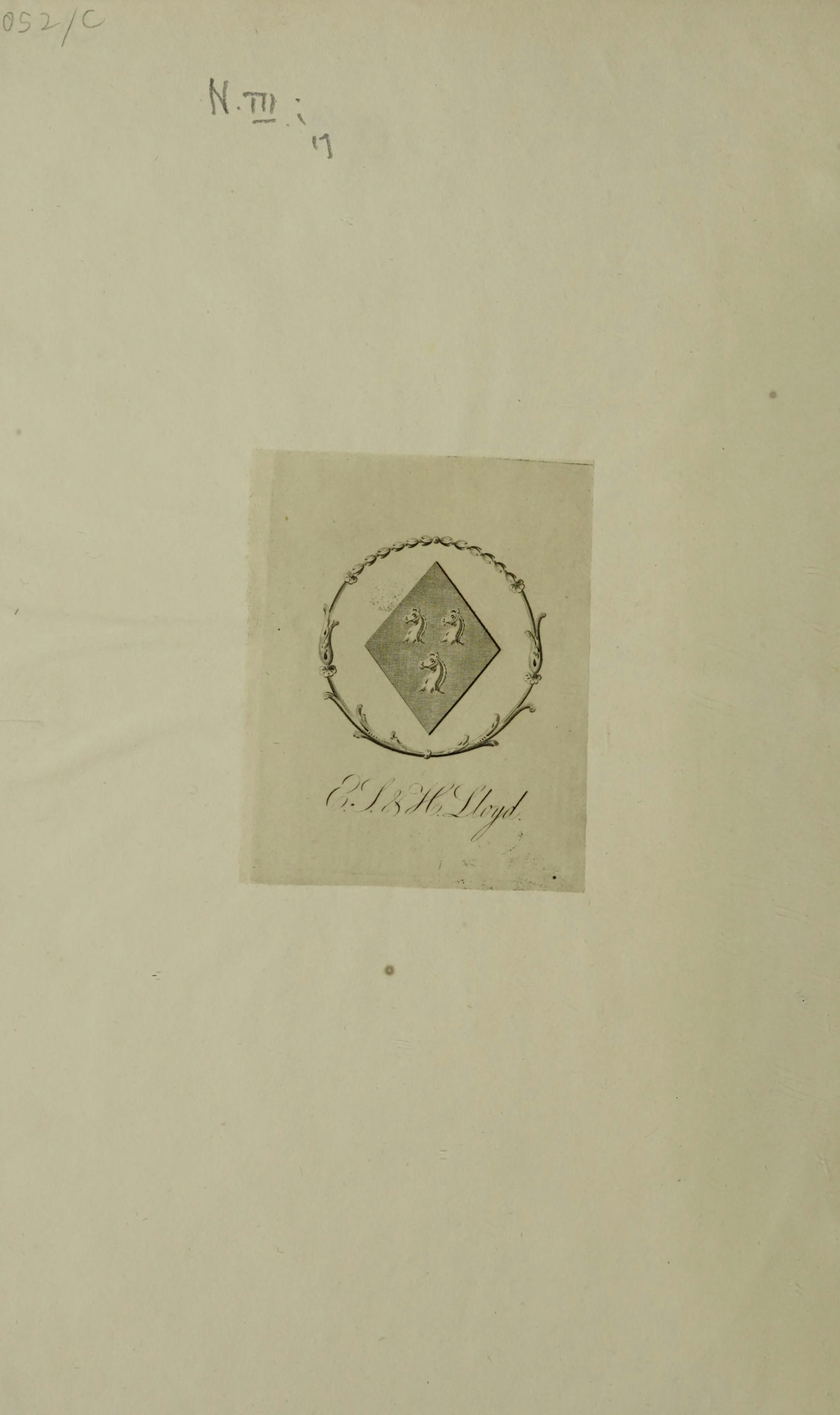 Bookplate depicting a diamond shaped coat of arms with three horses' heads within the circumference of a wreath. Below the wreath is written 'E.J. & H. Lloyd.'