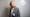 Portrait of Dr Camilla Mørk Røstvikis with tampons hanging out of the breast pocket of her blazer.