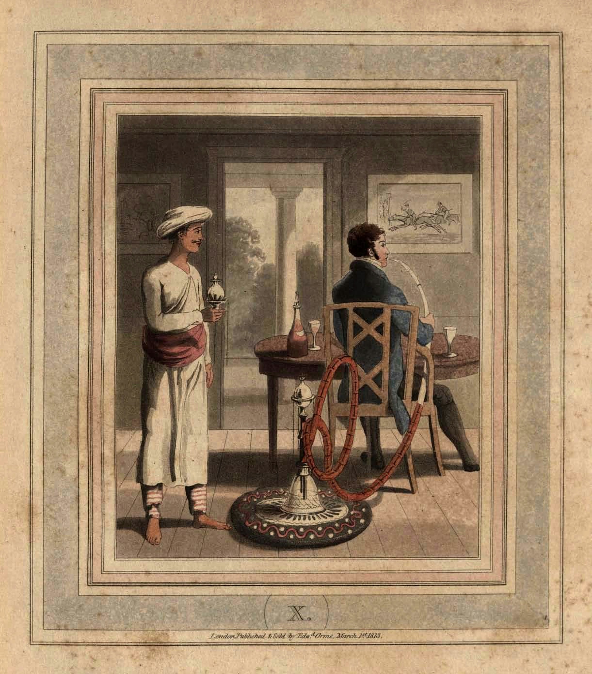 A European man sat at a table with his back to the viewer. He smokes a large hookah which is on the floor behind him, along with his Indian hookah baradur