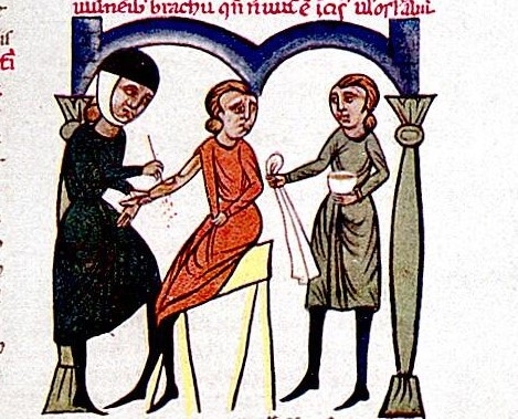 Colour reproduction of a 13th-century illustration showing a seated sad-looking patient with their sleeve pulled aside having blood let from their arm by a solemn figure wearing black and wielding a pointed implement. To the left of the figure stands a person holding a cloth and bowl. 