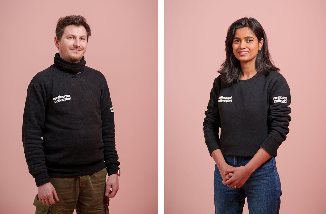 A young man and a young woman wearing tops with Wellcome Collection logos to show they are staff.