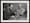 Photo with thick frame of a boy playing with small animal figurines and a man with a comb-over next to him.